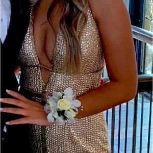 Beautiful gold sequined dress with a middle slit and partially open back.